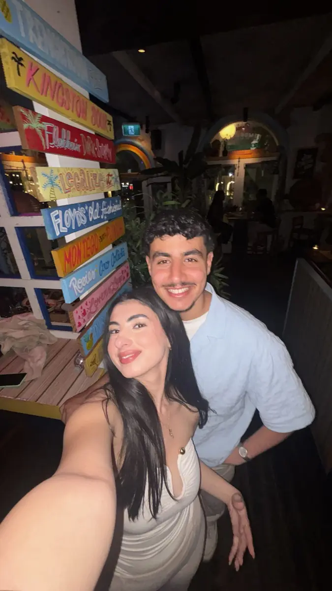 Salwa and Marchi beside painted cocktail signs